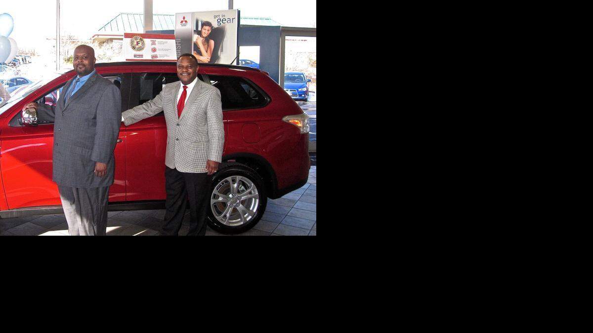 
Deon Willis, left, a floor manager at Jeremy Franklin Mitsubishi, and Jesse Hardin, a sales consultant for the manager, know about the numerous safety features of the Mitsubishi Outlander crossover.
