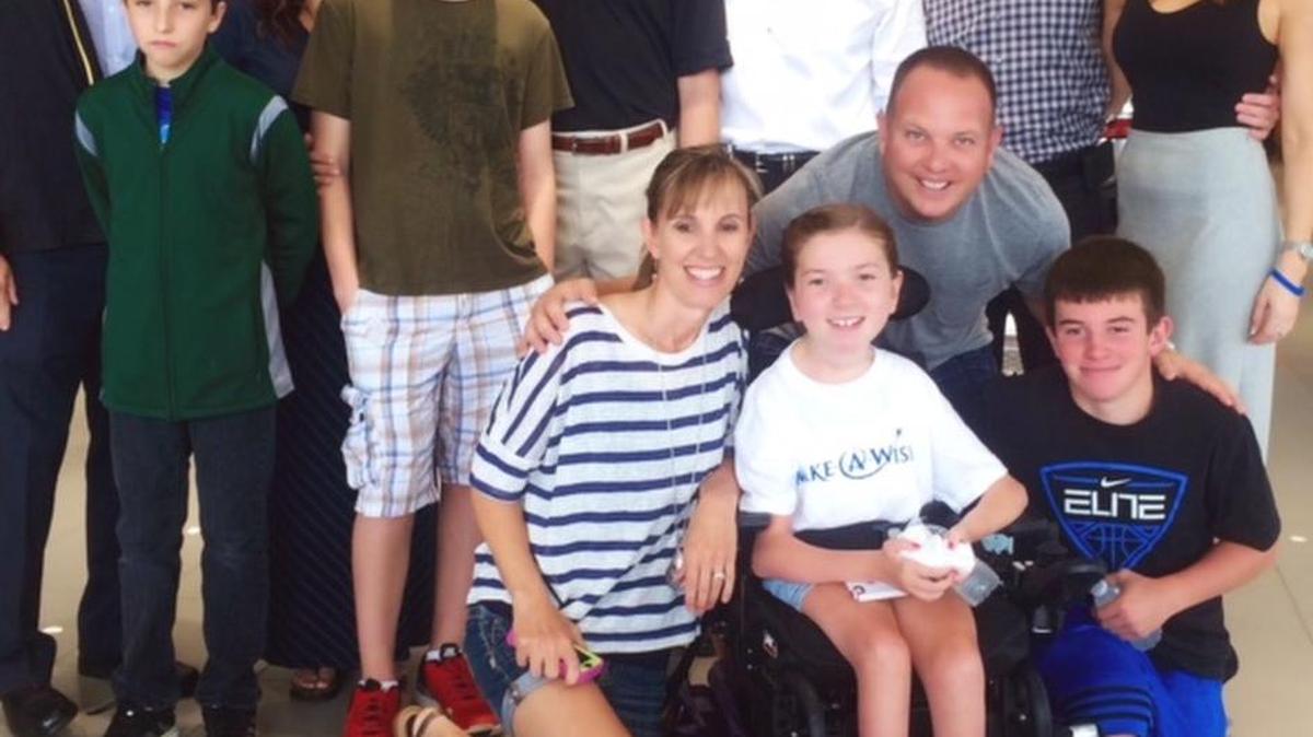 
The Lindsay and Tyler families at the Send Off Celebration at McCarthy Chevrolet in Olathe. Lindsay is in front, wearing a white T-shirt. Tyler is in the back row, wearing shorts.
