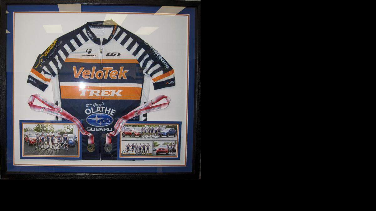 
Olathe Subaru, at 505 South Fir St., this year became the main sponsor for the Olathe Subaru Cycling team. This framed jersey and photos are displayed at the dealership.
