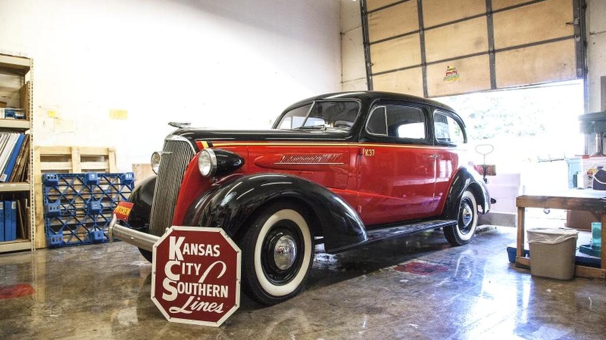 
Roy Thornton’s prize in his six-vehicle collection is his 1937 Chevrolet, which until recently was at his Merriam office. The Kansas City Southern Lines sign and the car’s color scheme were to honor his father, who worked there for 47 years. 
