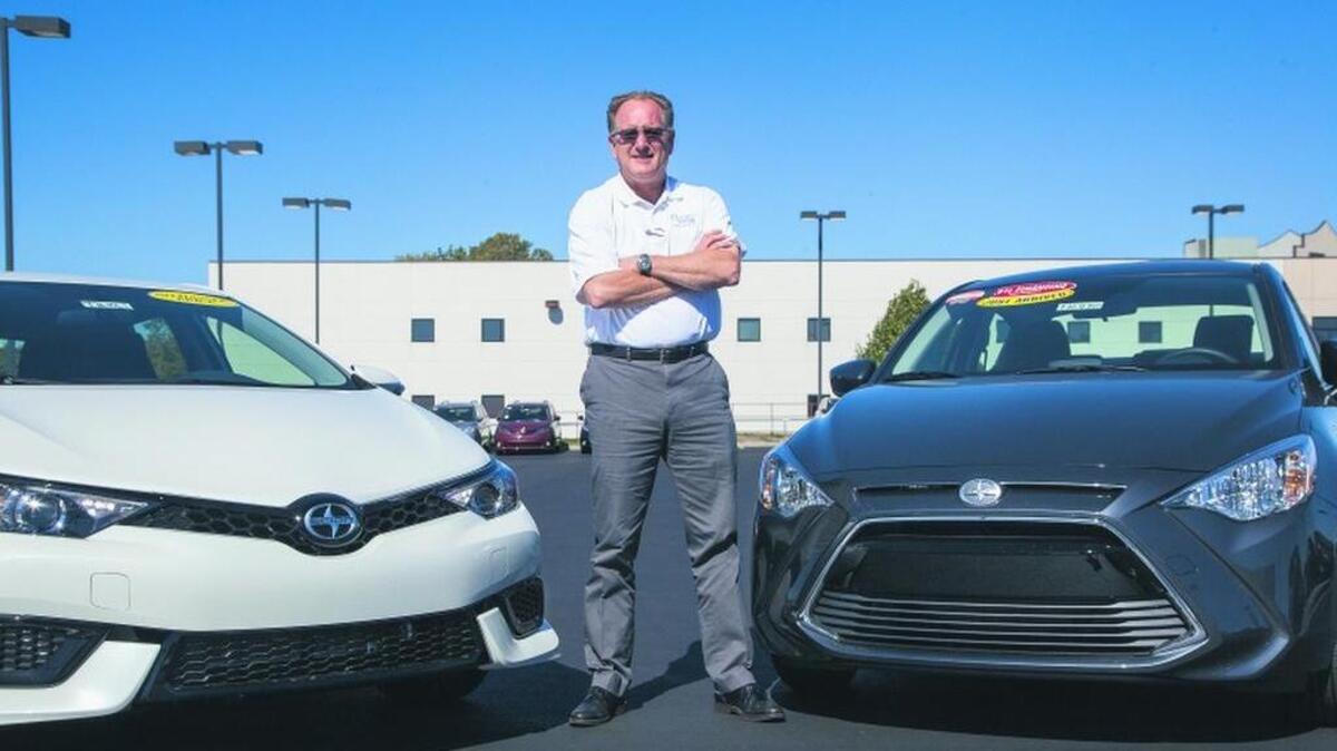 
Olathe Toyota Scion General Sales Manager Kenny Glasco stands between a 2016 Scion iM, left, and a 2016 Scion iA.
