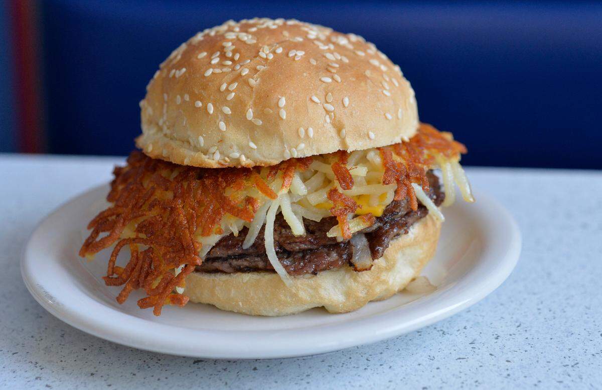 The Gen Dare and the Gen Dare Twin, with two meat patties (pictured), are bestsellers at Fritz’s Railroad Restaurant. These hamburgers are known for the hash browns that are added in addition to grilled onions, cheese, ketchup, mustard and pickles, served on a seeded bun.