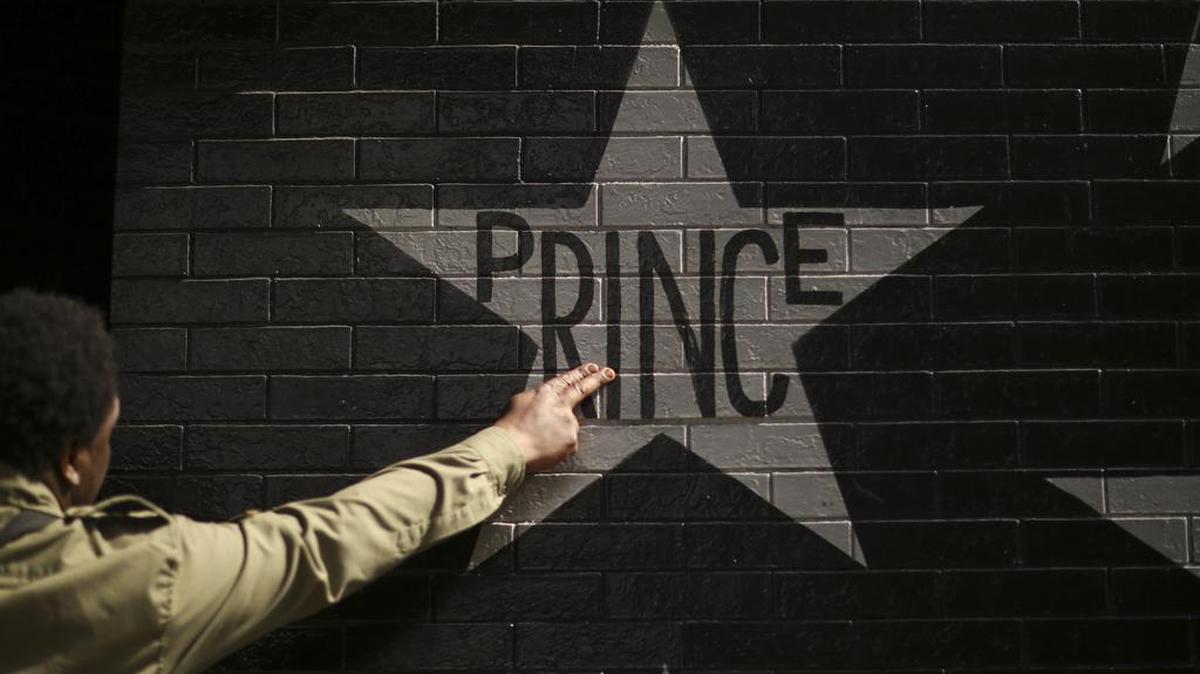 After kissing his fingers, a fan touches Prince's star on the wall of First Avenue in Minneapolis on Thursday, April 21, 2016 (Jeff Wheeler/Minneapolis Star Tribune/TNS)