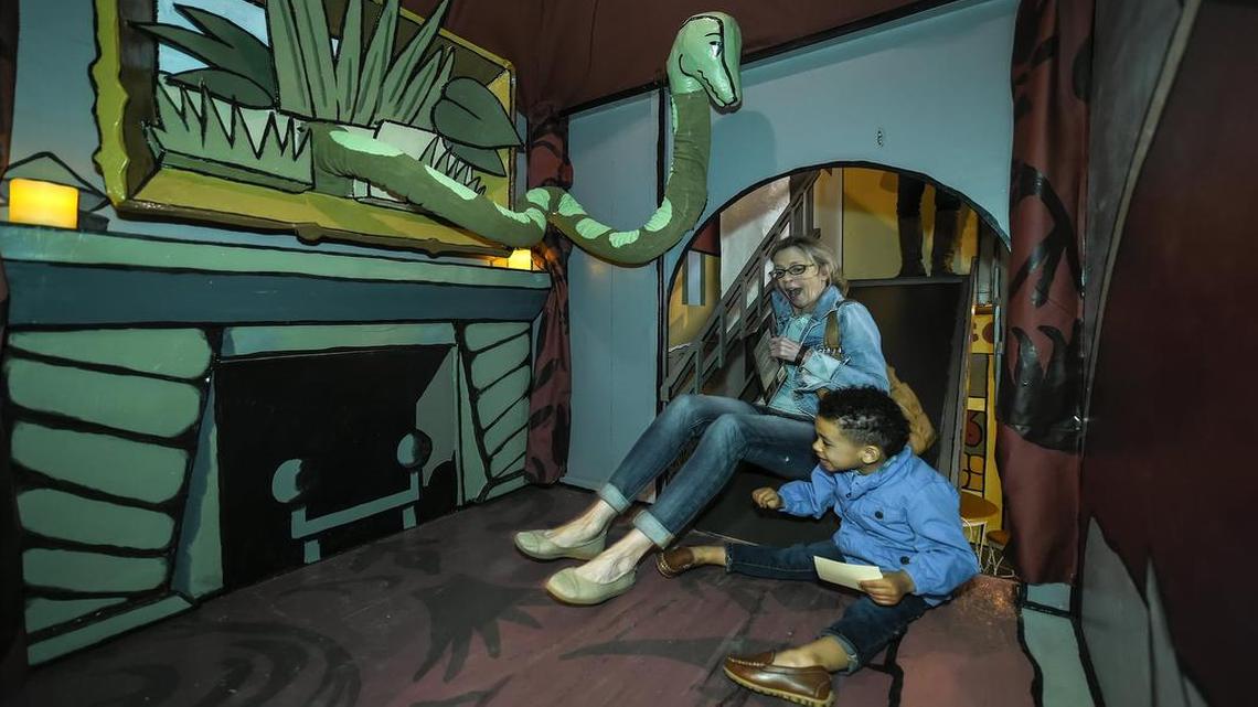 Kate Kloster of Prairie Village slid down a slide with her grandson, Miles Lollar, 2, during a 2016 visit to an earlier version of The Rabbit Hole. Jon Agee’s children’s book, “The Incredible Painting of Felix Clousseau,” had been enlarged into a two-story temporary exhibit.