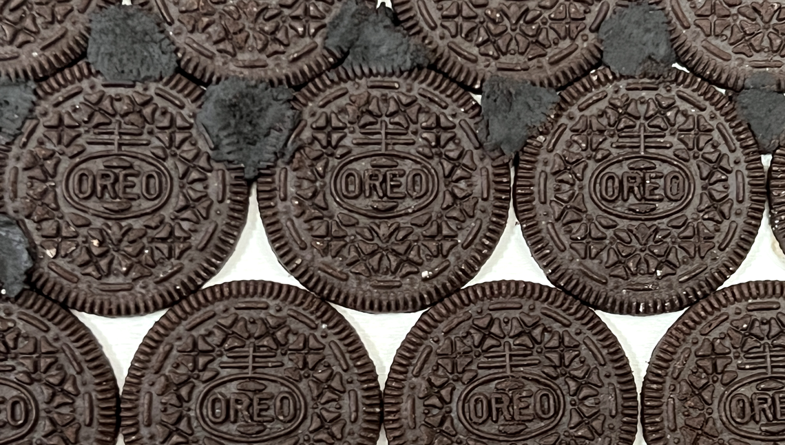 Oreo cookies lined up on a canvas serve as the background to an unfinished portrait by Kansas City artist Gabe Uvario. To fill in the gaps, he crushes up Oreos with Elmer’s glue in a sandwich bag, then pushes the dough-like result onto the canvas.