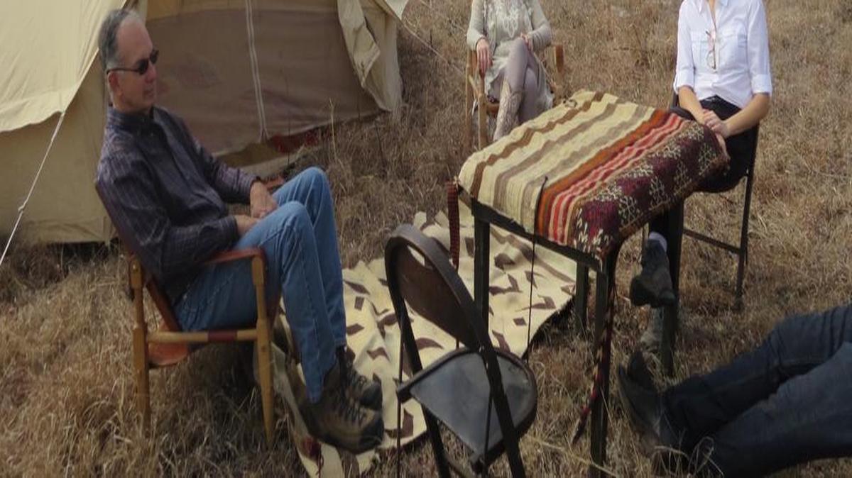 Clover Cliff Ranch owners Warren and Susie Harshman, left and center, try out handcrafted leather and wood camp chairs at a meeting on their land with Christy Davis, executive director of Symphony in the Flint Hills. The group was meeting with Randy Wolf and John O’Brien of Kansas City to work out details of a luxury encampment offered for the first time this year in conjunction with the outdoor concert.
