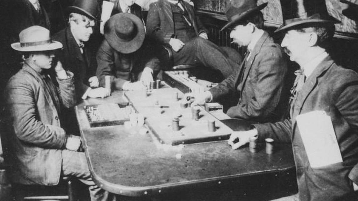 Men trying their luck “bucking the tiger” at a faro table in the 1800s.
