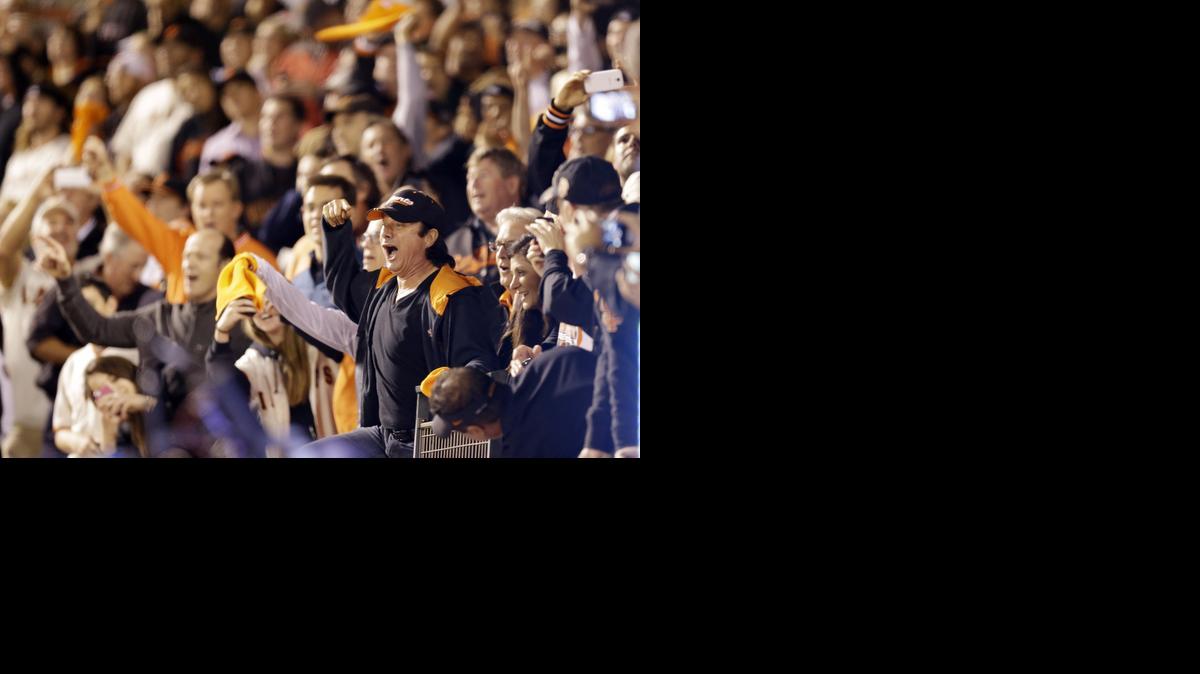 
Steve Perry, former lead singer for the band Journey sings with the crowd during the seventh inning of Game 5 of the National League baseball championship series against the St. Louis Cardinals in San Francisco. 

