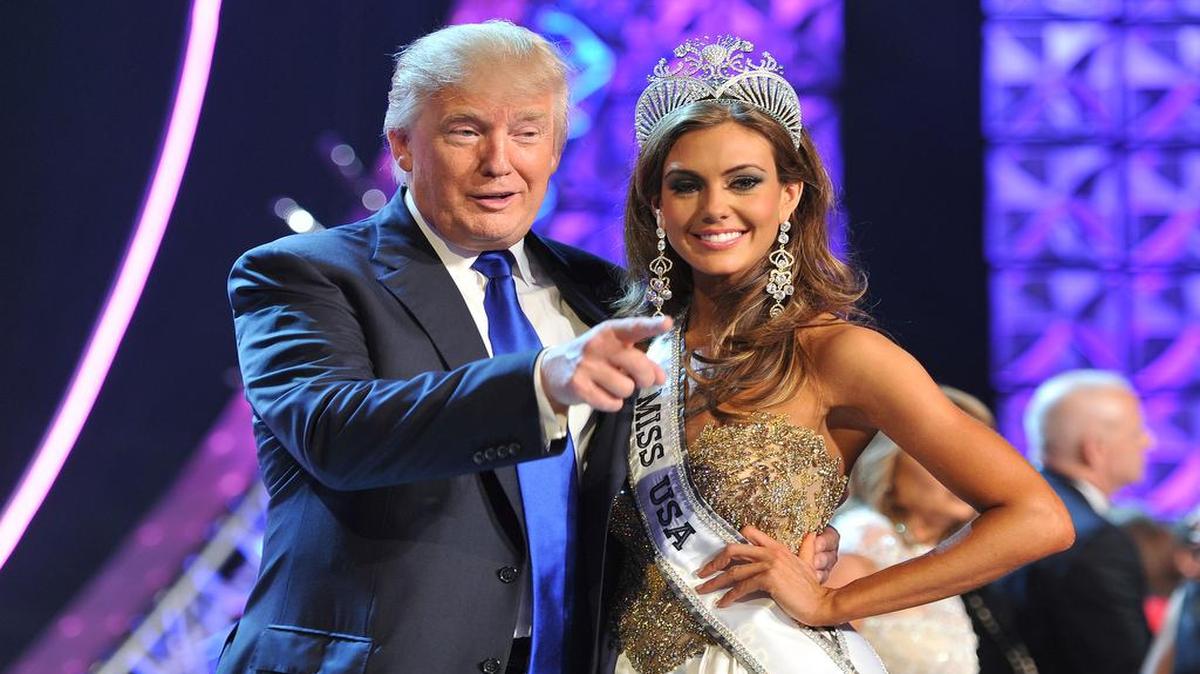 
Donald Trump and Miss Connecticut USA Erin Brady pose onstage after Brady won the 2013 Miss USA pageant in Las Vegas, Nev. Univision says it is dropping the Miss USA Pageant and says it will cut all business ties with Donald Trump over comments he made about Mexican immigrants. 

