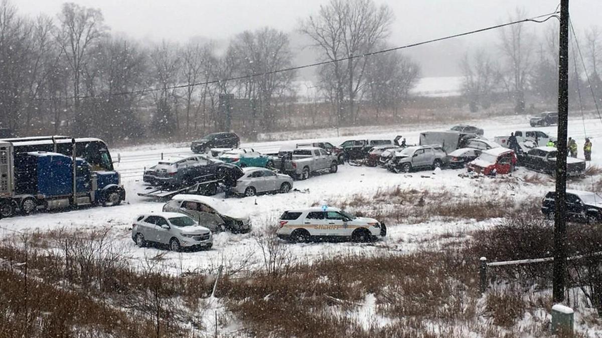 In this photo provided by KCCI-TV, emergency personnel tend to vehicles on Interstate 35 in Ames, Iowa, after dozens of vehicles collided on the snow-covered freeway Monday, Feb. 5, forcing the closure of the southbound lanes.