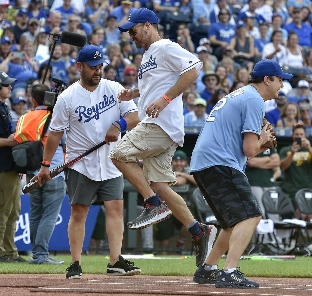 Will Forte leaps onto home to score during the 2018 Big Slick Celebrity Softball game at Kauffman Stadium.