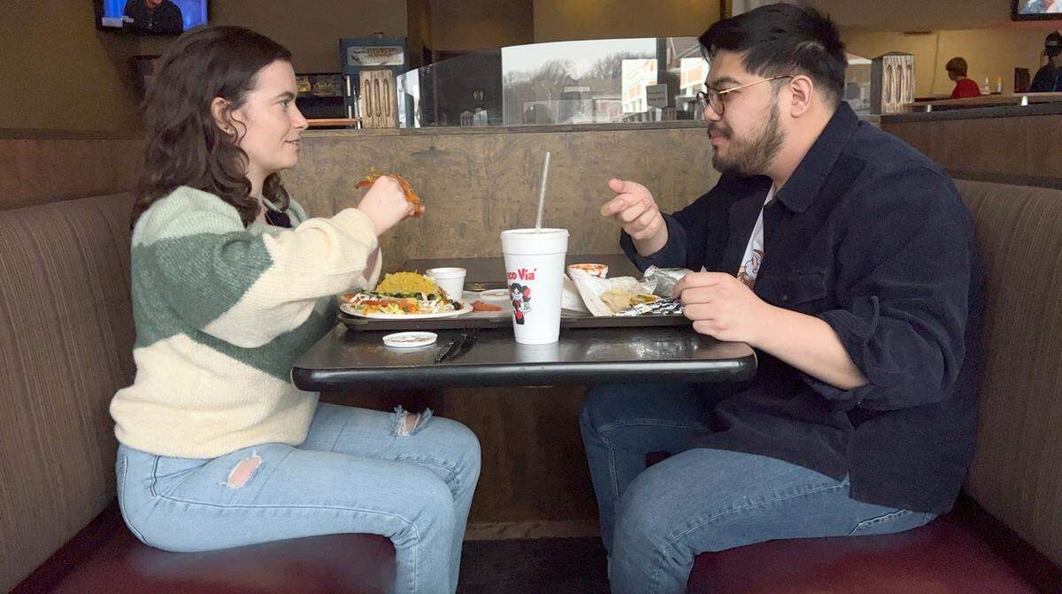 Kansas City Star reporter Andrea Klick and her boyfriend, Leon Chan, sample the nacho at Taco Via in Overland Park.