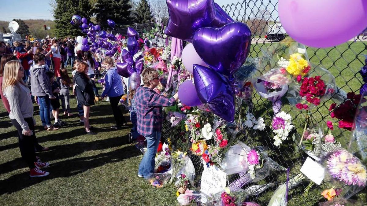 A memorial fence in memory of Prince is lined with flowers and signs at Paisley Park Studios Friday in Chanhassen, Minn. Prince died Thursday at Paisley Park at the age of 57. \
