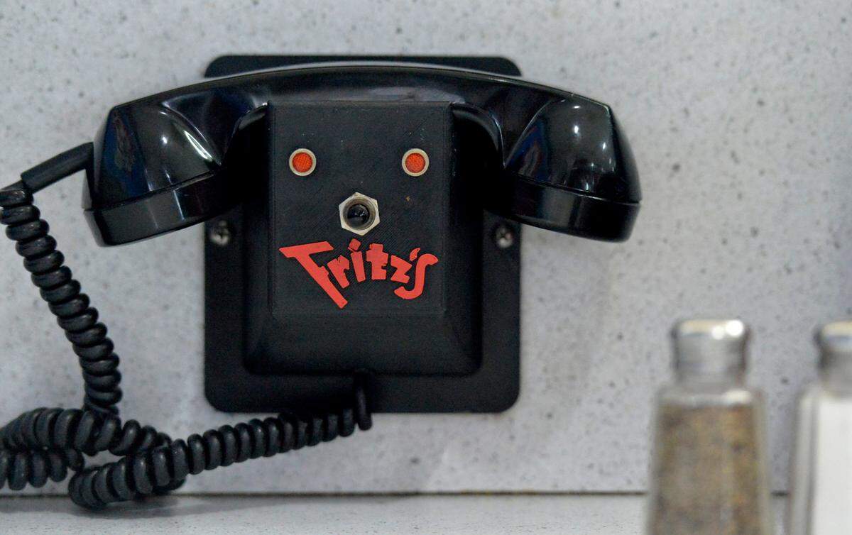 Customers at Fritz’s restaurants call in orders with the phones at their table.