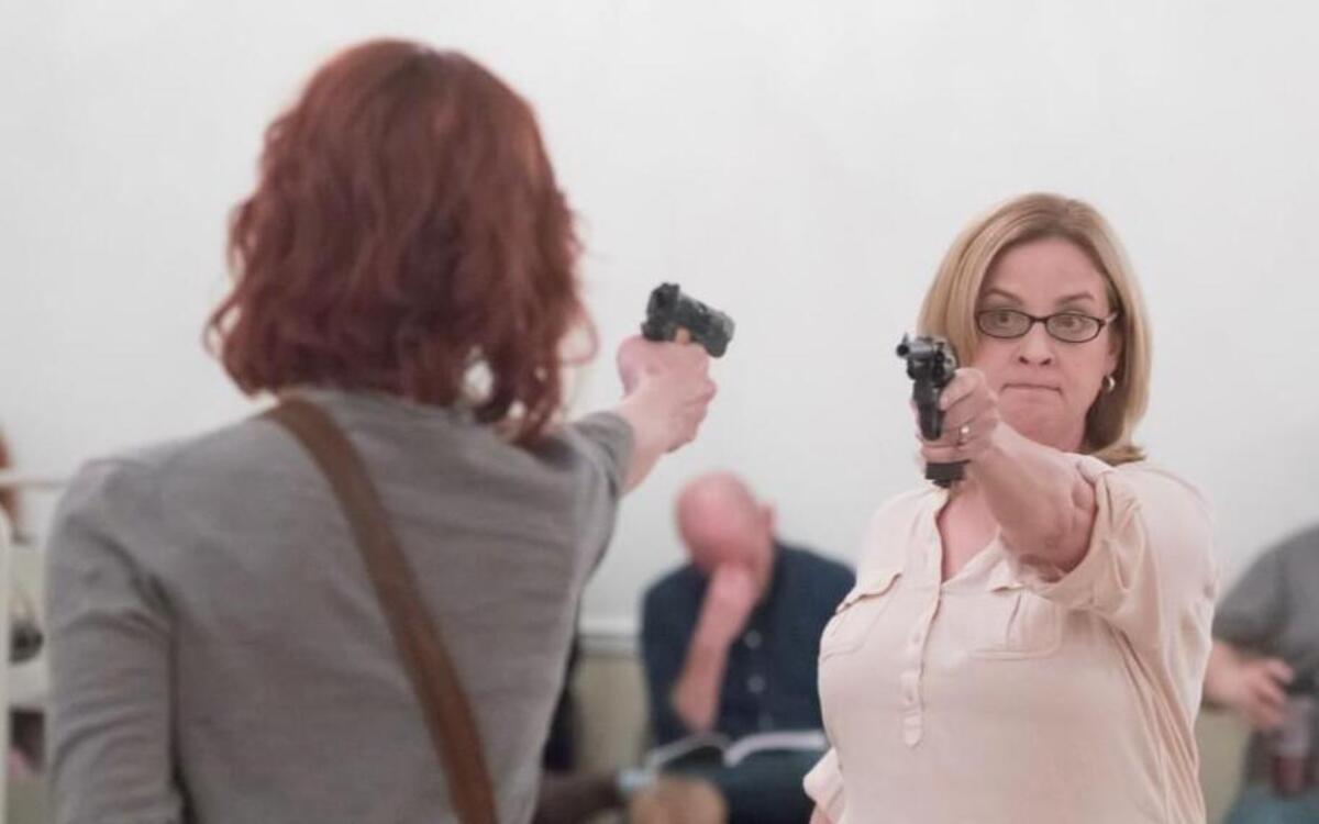 “Assassins” includes Sara Jane Moore (Julie Shaw, right, in rehearsal) and Lynette “Squeaky” Fromme (Liz Golson), who both tried to kill President Gerald Ford.