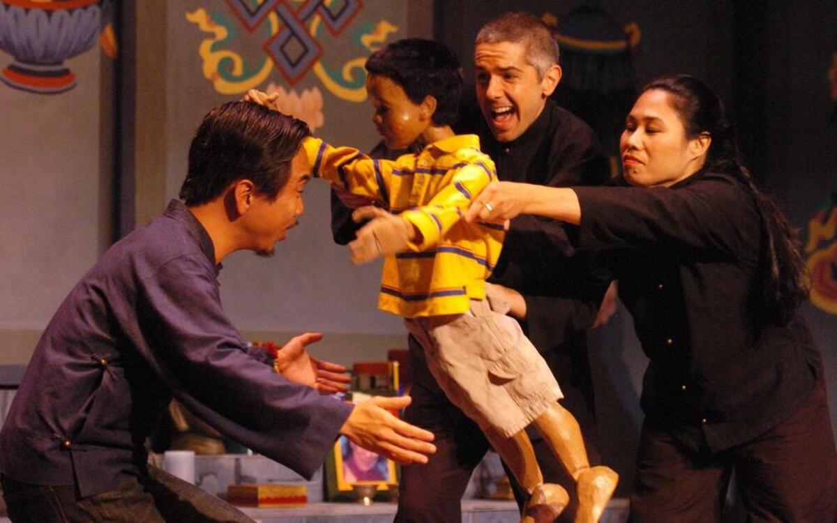 
Alex Espy (center, who also is the voice of the boy) and Andi Meyer serve as puppeteers in the Unicorn Theatre’s new production. Tran is at left. 
