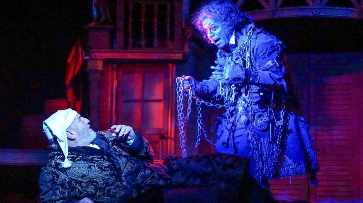 Ebenezer Scrooge (Gary Neal Johnson) is confronted by the ghost of Jacob Marley (Walter Coppage) in “A Christmas Carol.”