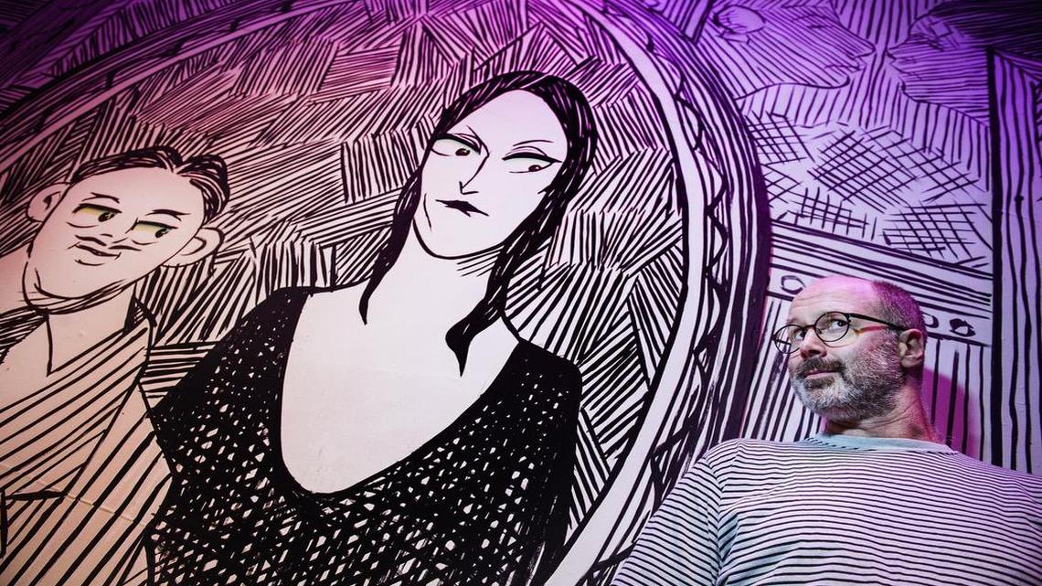 
Charles Moore, scenic art designer for “The Addams Family” at the New Theatre in Overland Park, with the sets he created for the play. He designed the sets to look like intricate pen-and-ink drawings. 
