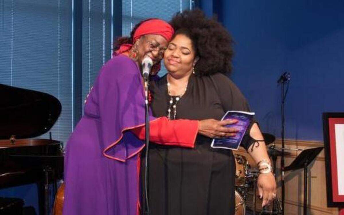 
The organizer of the Women in the Arts KC event, Mary Moore (left), served as emcee on Sunday and hugged Sheri “Purpose” Hall, a spoken word poet who had just performed. The fundraiser at the Blue Room in the 18th and Vine district raised money for homeless women in the area.
