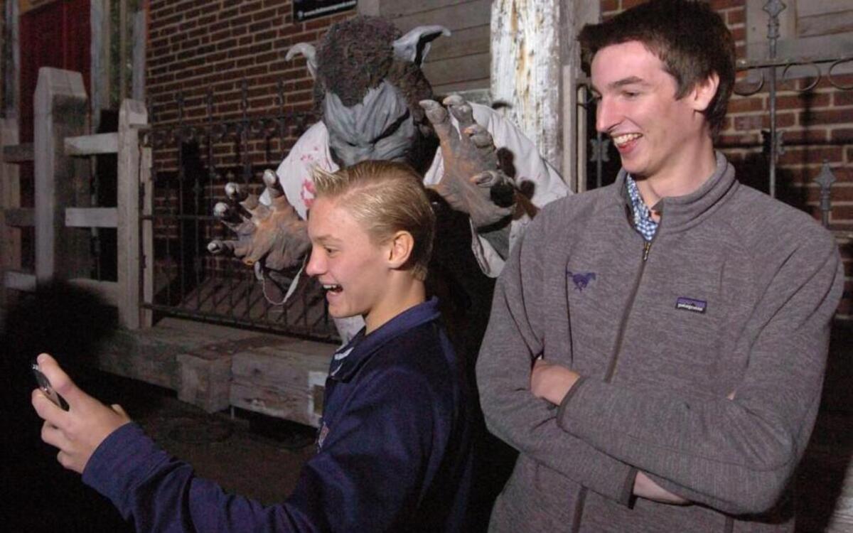 Jackson Rhodes (left) took a selfie of him and friend Liam North, both of Overland Park, with Wolfie, portrayed by Ryan Frost of Kansas City. Rhodes and North were in line at The Beast in the West Bottoms.
