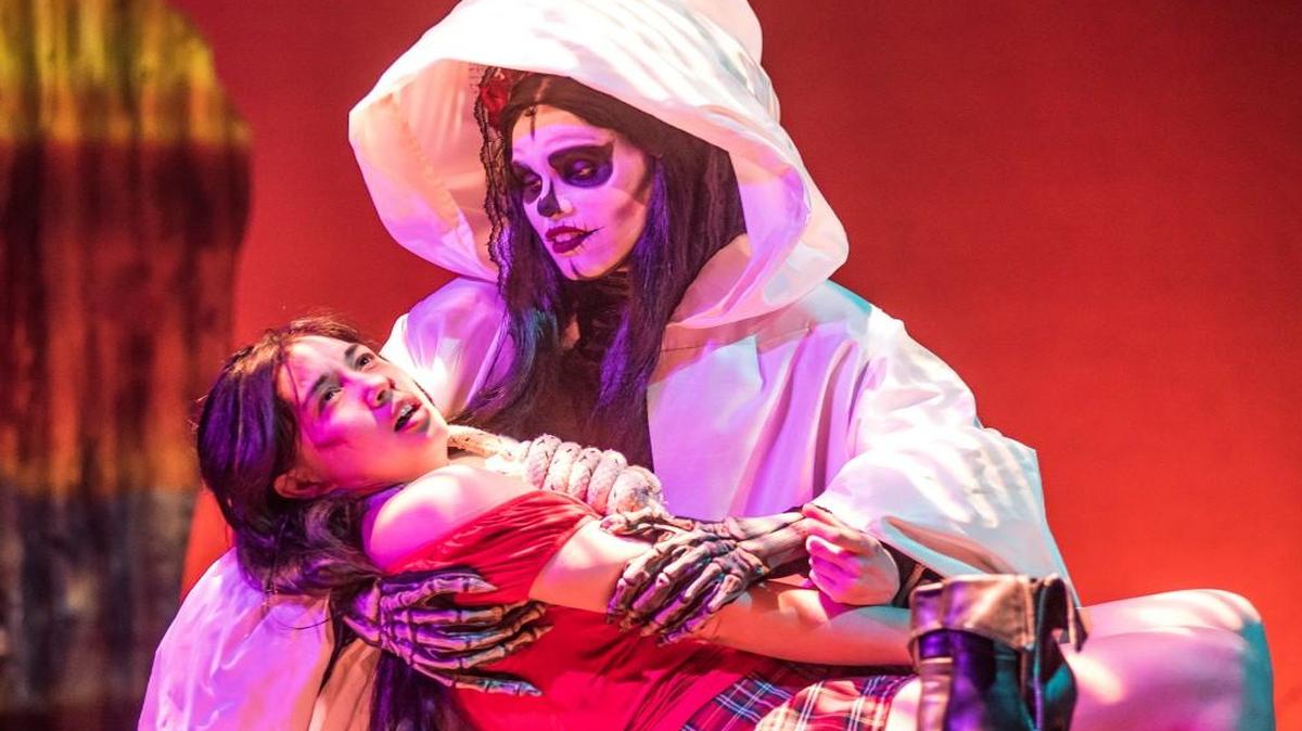 Raquel Cantu (Rebecca Munoz) is comforted by La Santa Muerte (Meredith Wolfe) in the Unicorn Theatre’s “The Ghosts of Lote Bravo.”
