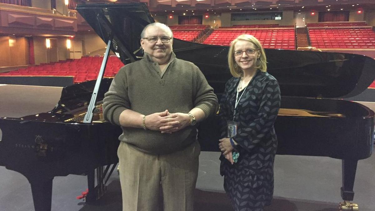 Peter Goulet and Emily Behrmann show off the 9-foot-long Steinway piano that Goulet bought for Johnson County Community College.