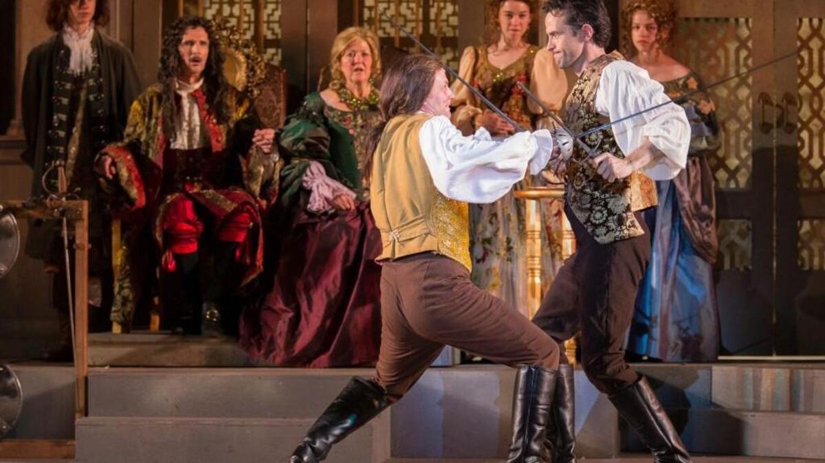 Hamlet (Nathan Darrow, right) and Laertes (Matt Schwader) do battle as (background from left) an attendant (Roan Ricker), Claudius (Bruce Roach), Gertrude (Jan Rogge) and more attendants Leah Wilczewski and Haddy Wilczewski) look on.