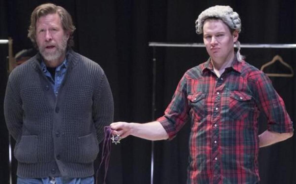 During a rehearsal for “Shipwrecked!” Louis de Rougemont (Charles Fugate, left) informs the audience of his legal troubles as a lawyer (Bob Linebarger) strips him of a medal.