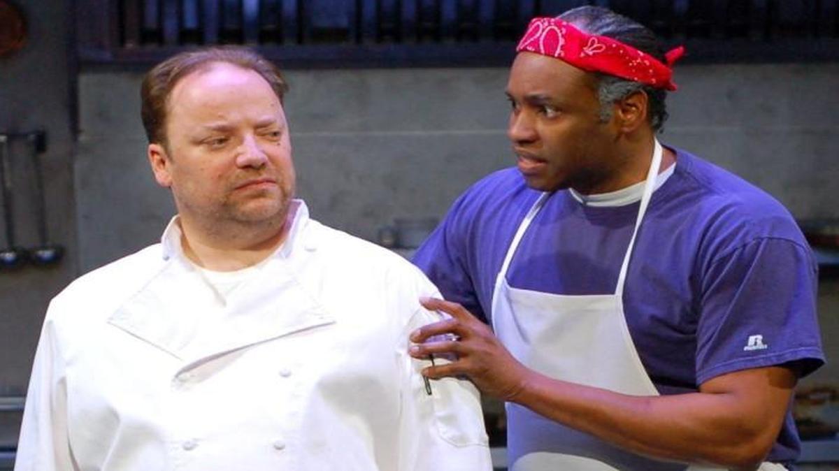 In “How to Use a Knife,” a former high-end chef (Matt Rapport, left) is now the kitchen boss at a hamburger joint, where Steve (Damron Russel Armstrong) is the dishwasher. The production runs through Feb. 19 at the Unicorn Theatre.
