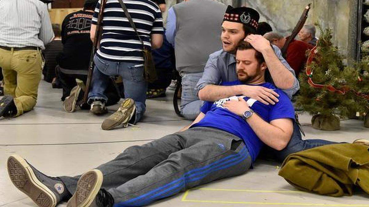 
In a rehearsal scene from the Lyric Opera’s “Silent Night,” soldiers from opposing sides pray as Scottish soldier Jonathan Dale, played by David Blalock, mourns his brother William Dale, played by Caleb C. Ashby.
