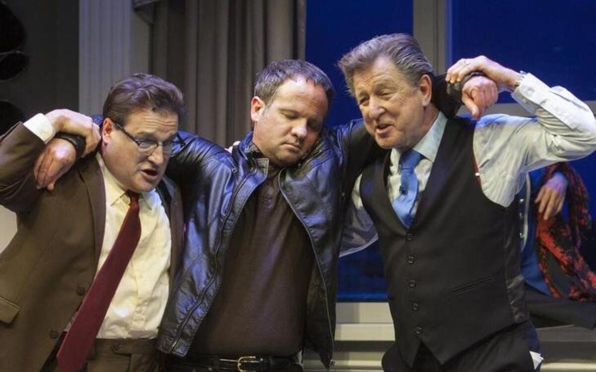 Craig Benton, (left) as a political aide and Gary Sandy (right) as a U.S. Senator carry Jason Miller as someone they believe is dead in “Out Of Order.”