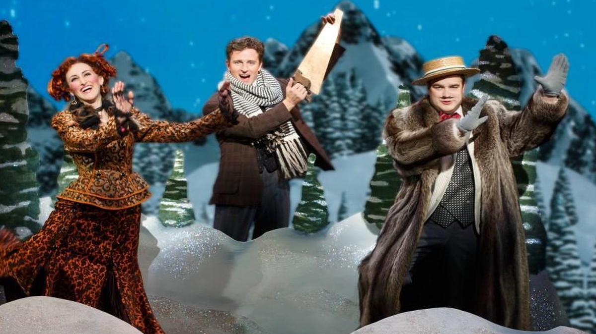 While ice skating, a greedy relative (John Rapson, right) and his mistress (Lesley McKinnell) are sent to their untimely death by the adorably conniving Monty (Kevin Massey).