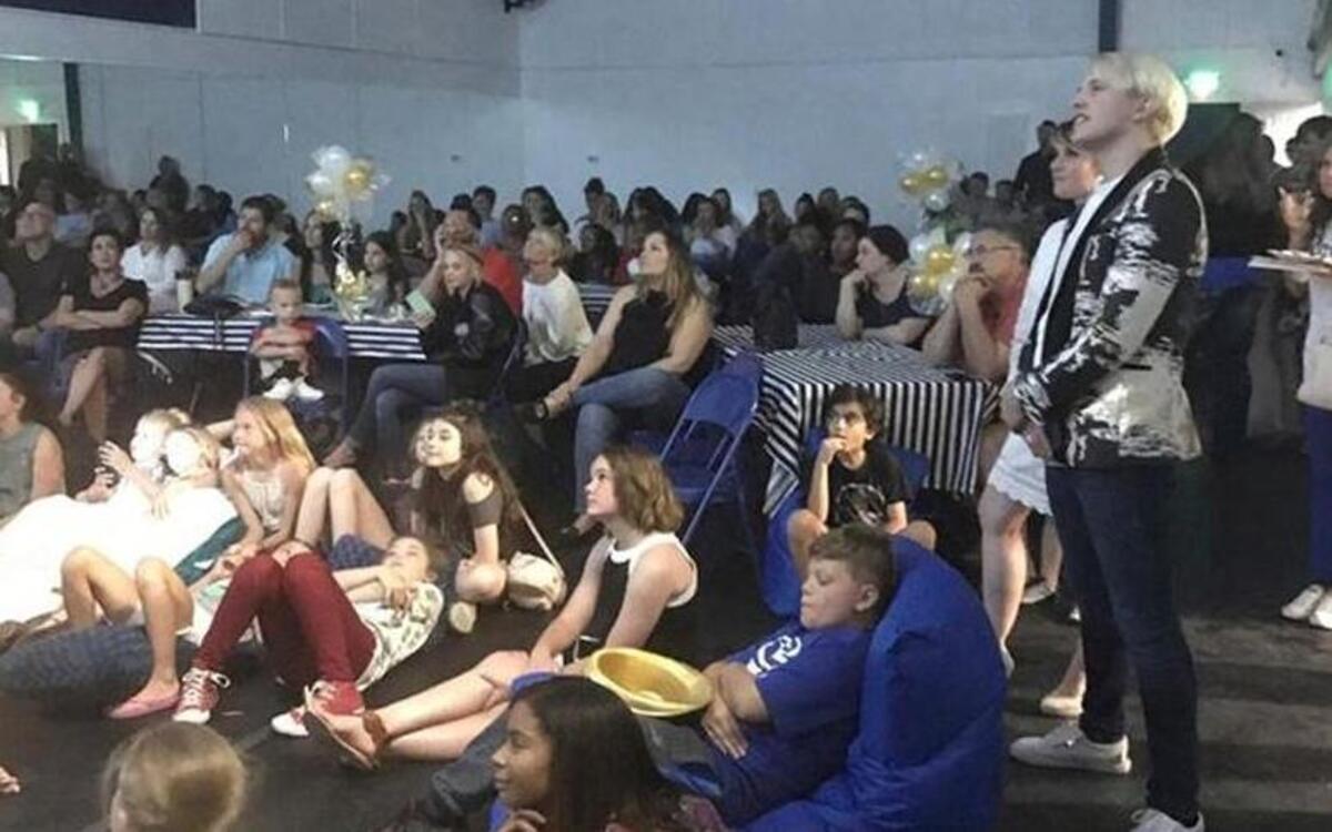 Blake Piatczyc (standing, far right) watches the “World of Dance” premiere episode with family, friends and supporters at his soon-to-open studio, BPM Dance Complex in Lee’s Summit.