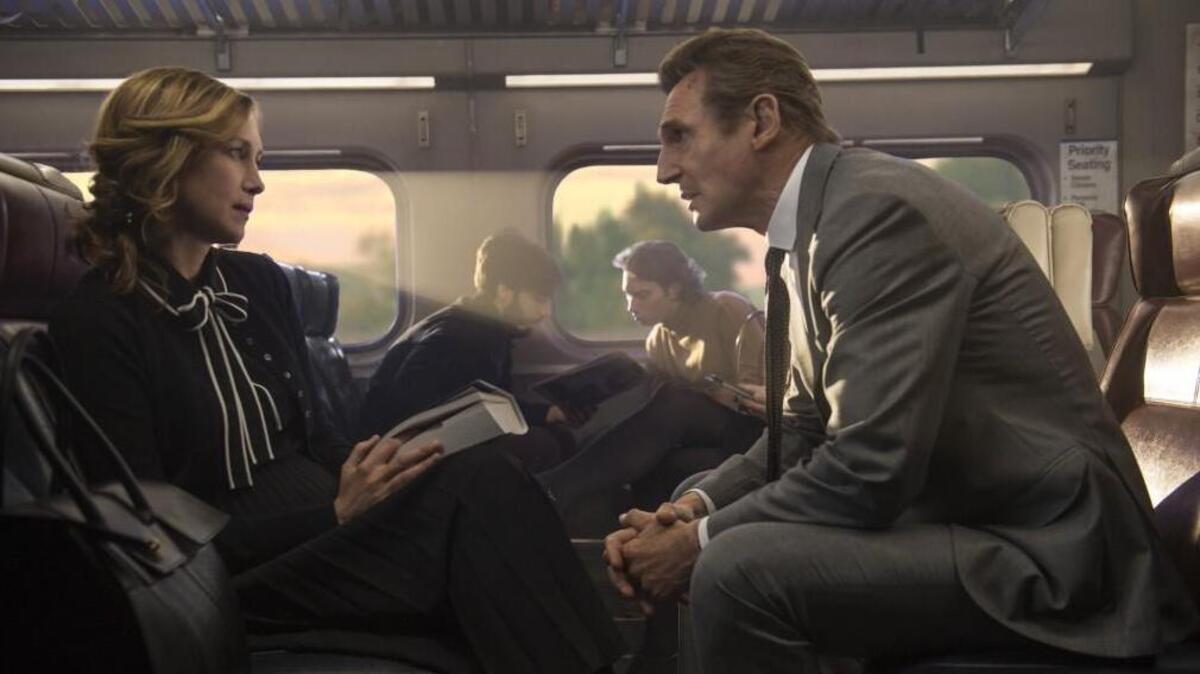 A mysterious woman (Vera Farmiga) draws ex-cop Michael (Liam Neeson) into a murderous conspiracy in “The Commuter.”