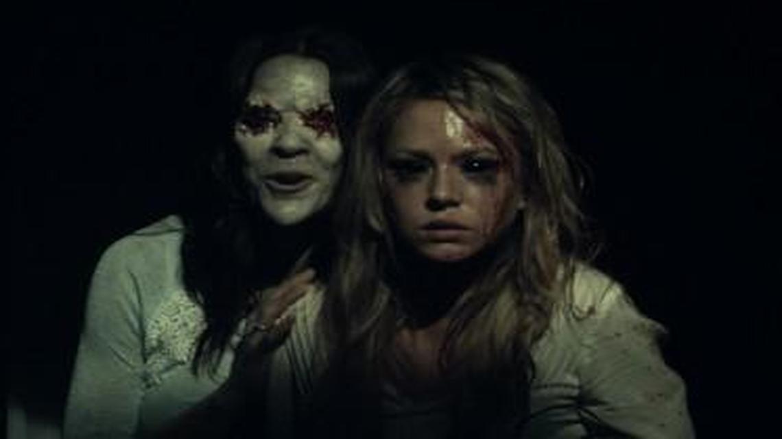 An evil spirit haunts a visitor (Tara Holt) at an abandoned house.