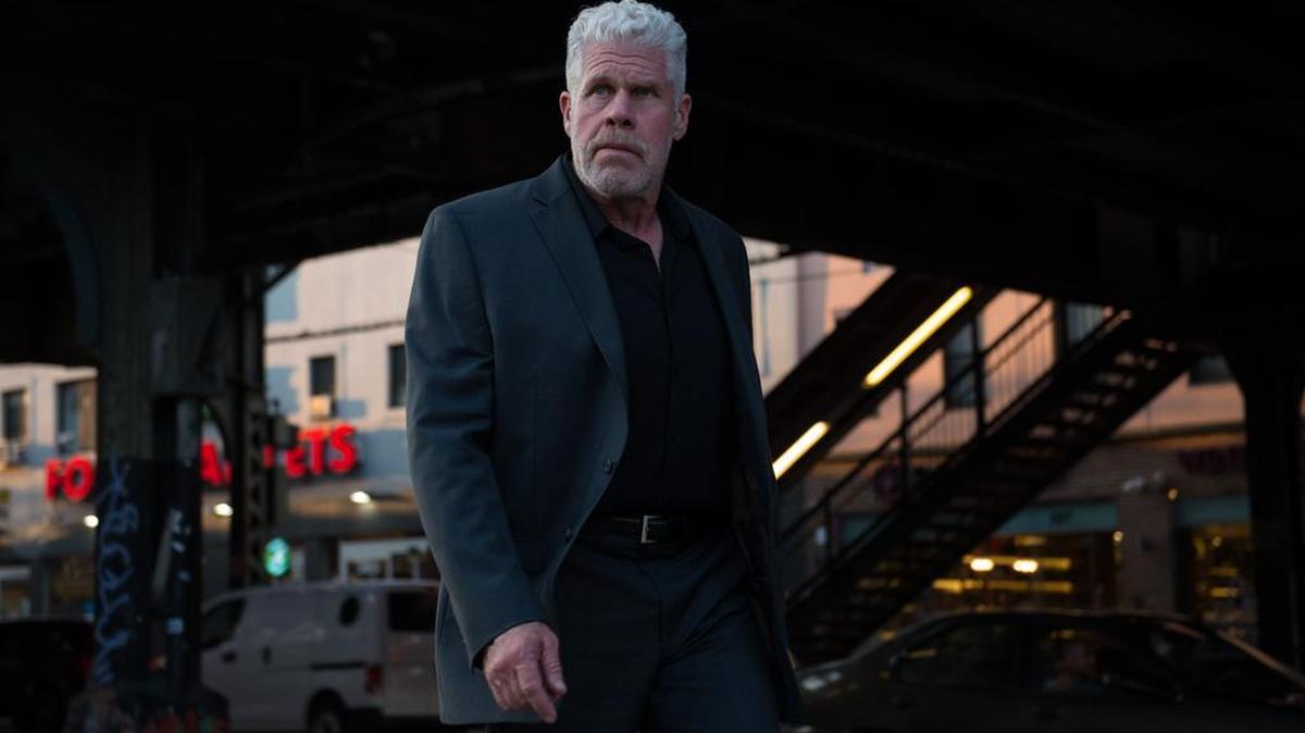 Asher (Ron Perlman) is a former Mossad agent turned gun for hire.