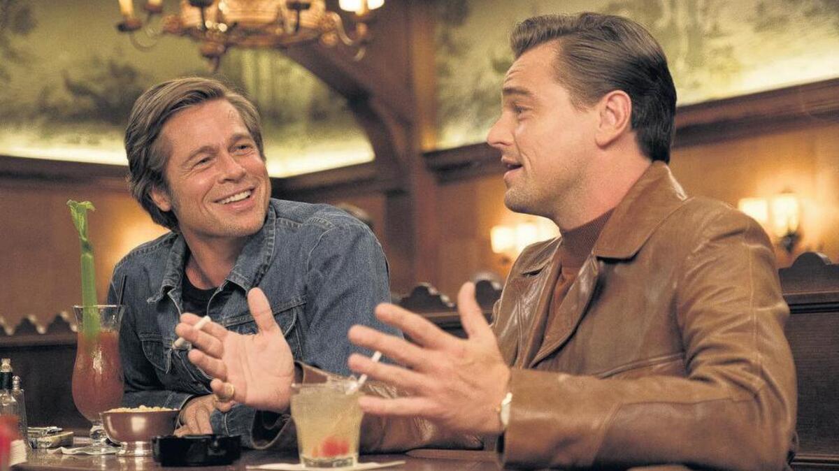 A stunt double (Brad Pitt, left) is the only friend to a faded movie star (Leonardo DiCaprio) in “Once Upon a Time... In Hollywood.”