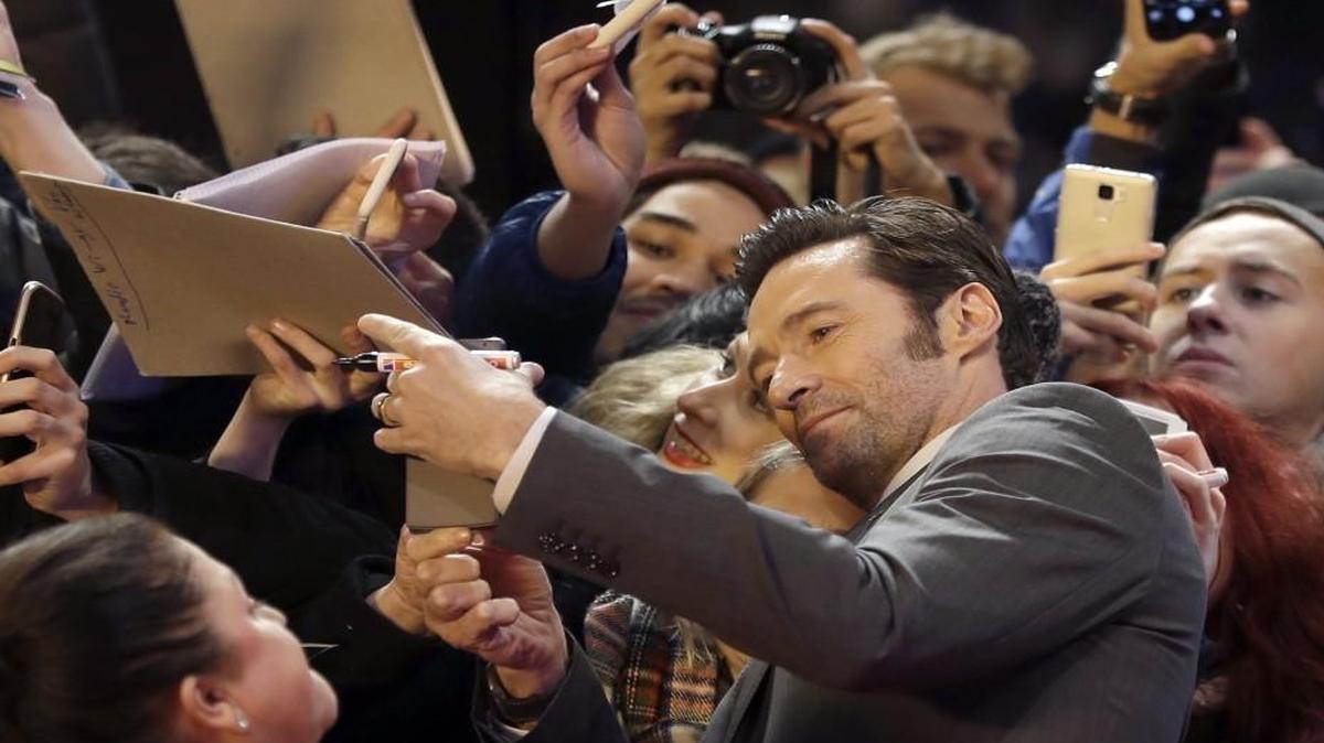 Hugh Jackman feels the fan love on the red carpet for “Logan” in Berlin.