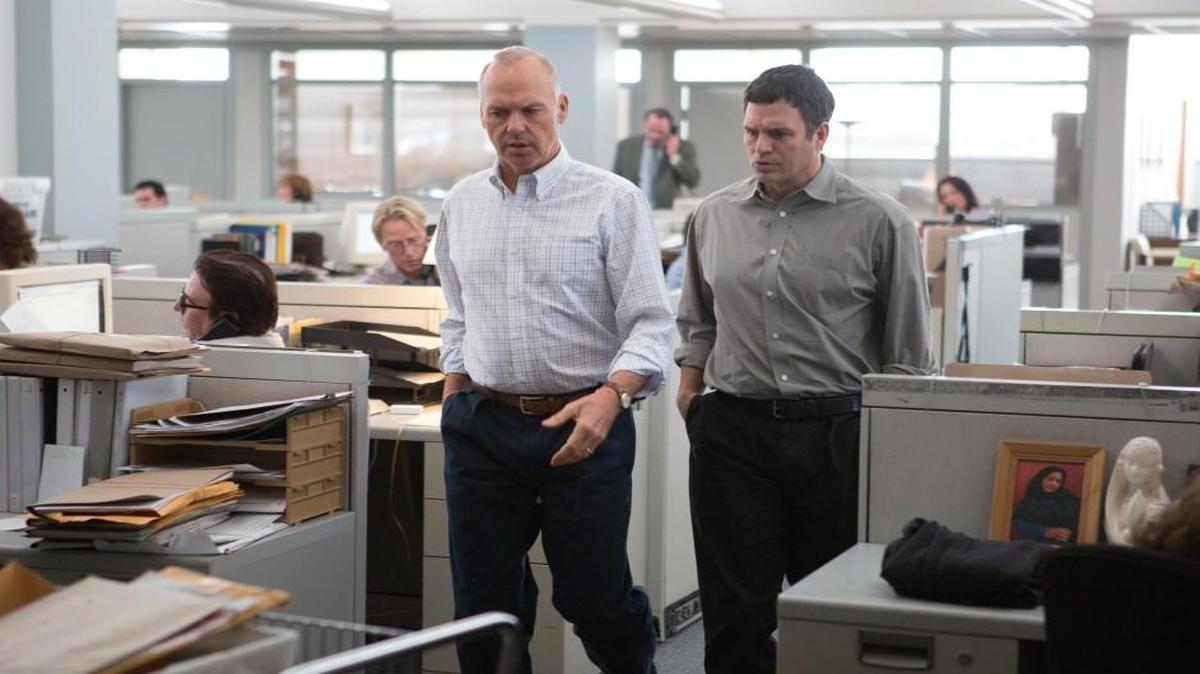 Ahh, the fluorescent lights and cluttered desks of a newsroom. The leader of the Boston Globe’s Spotlight team (Michael Keaton, left) and one of his ace reporters (Mark Ruffalo) plot their investigation.