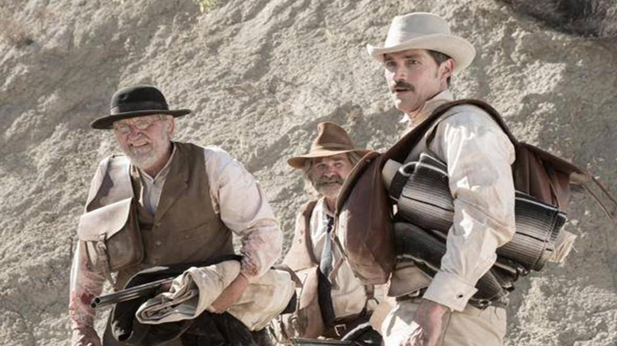 In the old West, a posse (from left, Richard Jenkins, Kurt Russell and Matthew Fox) is out to rescue captives from cannibals.