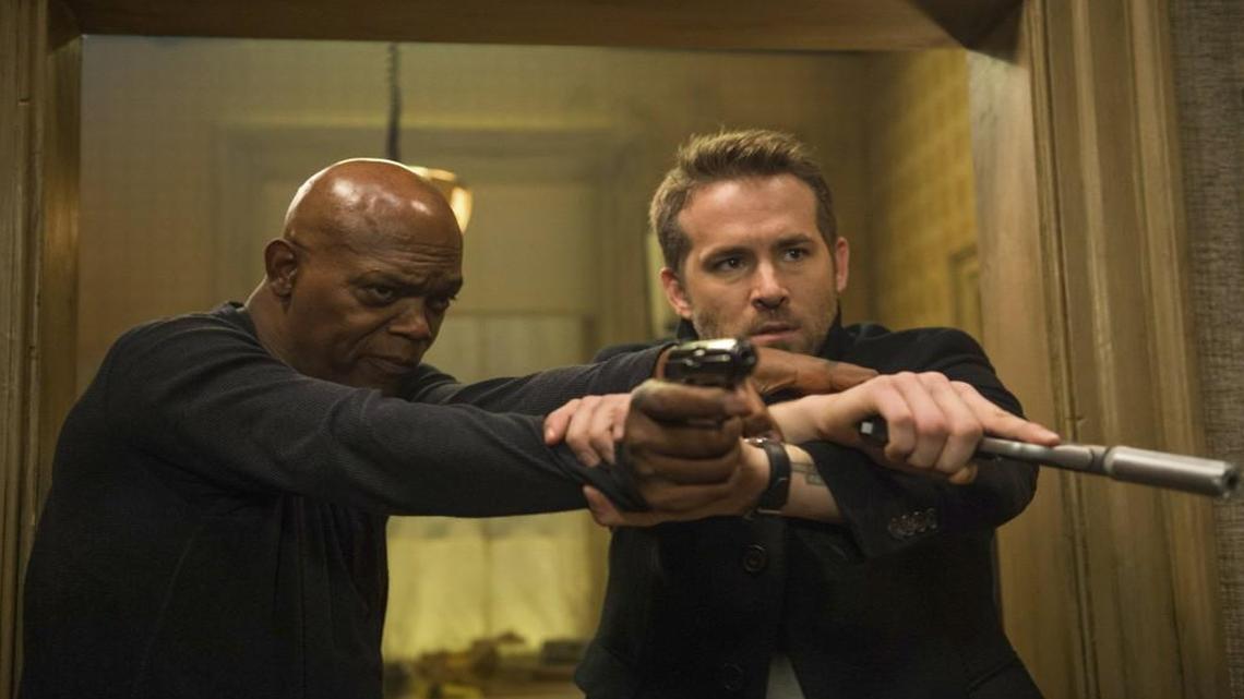 An assassin (Samuel L. Jackson, left) makes his bodyguard’s (Ryan Reynolds) job difficult.