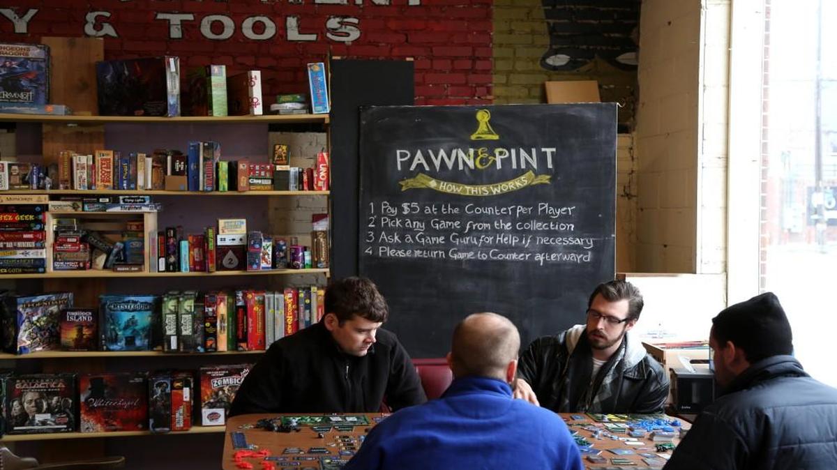 Richard Moorhead (from left), John Rake, David Wagner and Tom Carroll play Twilight Imperium at Pawn and Pint, which provides more than 800 board games.