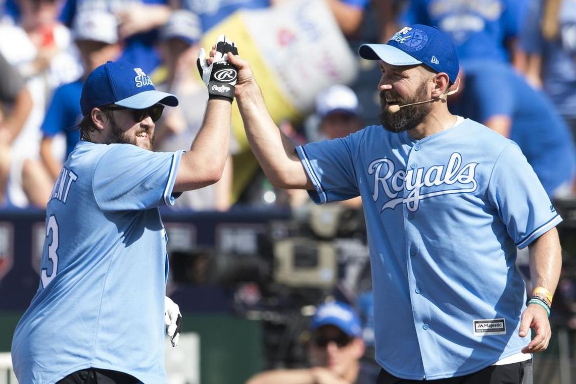 Haley Joel Osment, left, was welcomed to first base by Big Slick host Paul Rudd during a celebrity softball game at Kauffman Stadium.