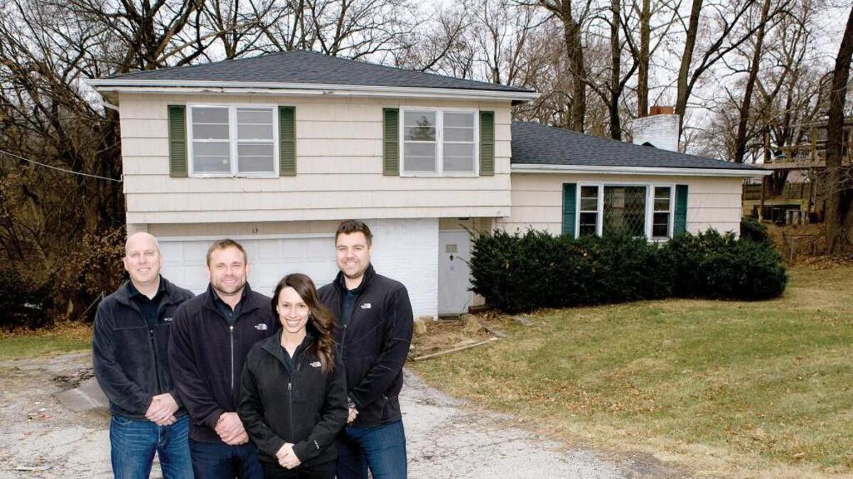The House Buyers KC team prepares a recently acquired property for repairs and construction. The team, from left: Kyle Walchshauser, Chad Lower, Katie Mason and Tom Bell.