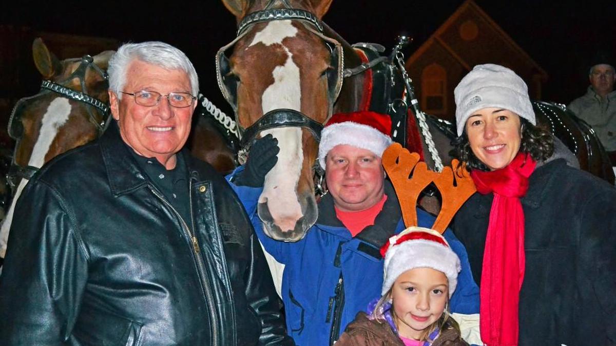 Darol Rodrock, left, at one of his community’s holiday hayrides, one of the many amenities of living in a Rodrock Development community.
