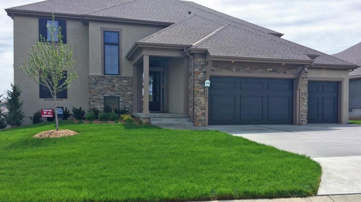 This 1 ½-story home with a finished walkout basement is offered by Dan Smith Home Building Co. at 13403 W. 169th Terrace. The 4,500-square-foot home is priced at $574,950 and features six bedrooms and five bathrooms.
