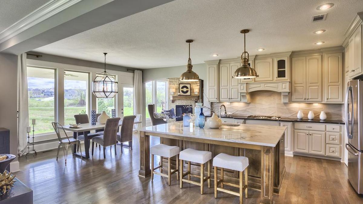 The gourmet-inspired kitchen in the two-story, five-bedroom Larsen EX floor plan (immediate purchase, $623,000) is equipped to handle weeknight family dinners or entertaining.