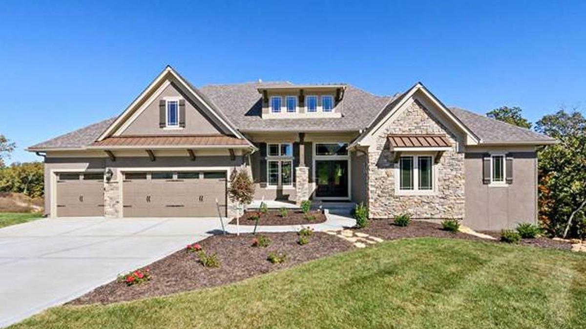 The Destination, a reverse 1½ story executive home built by Pfeifer Homes, is situated in a prime spot on the “100-Acre Woods.” There are very few homes available in this scenic area.