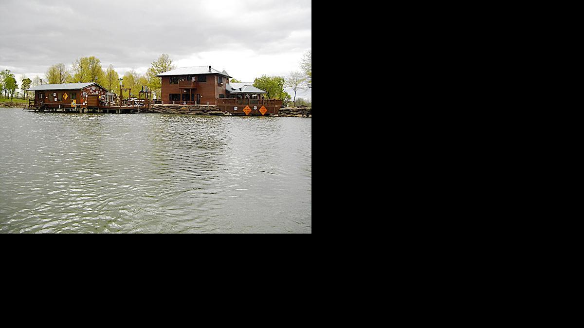 
Albert and Mary Lynne Cornell’s log-sided home overlooks a 10-acre lake with boat house on their 80-acre property. 
