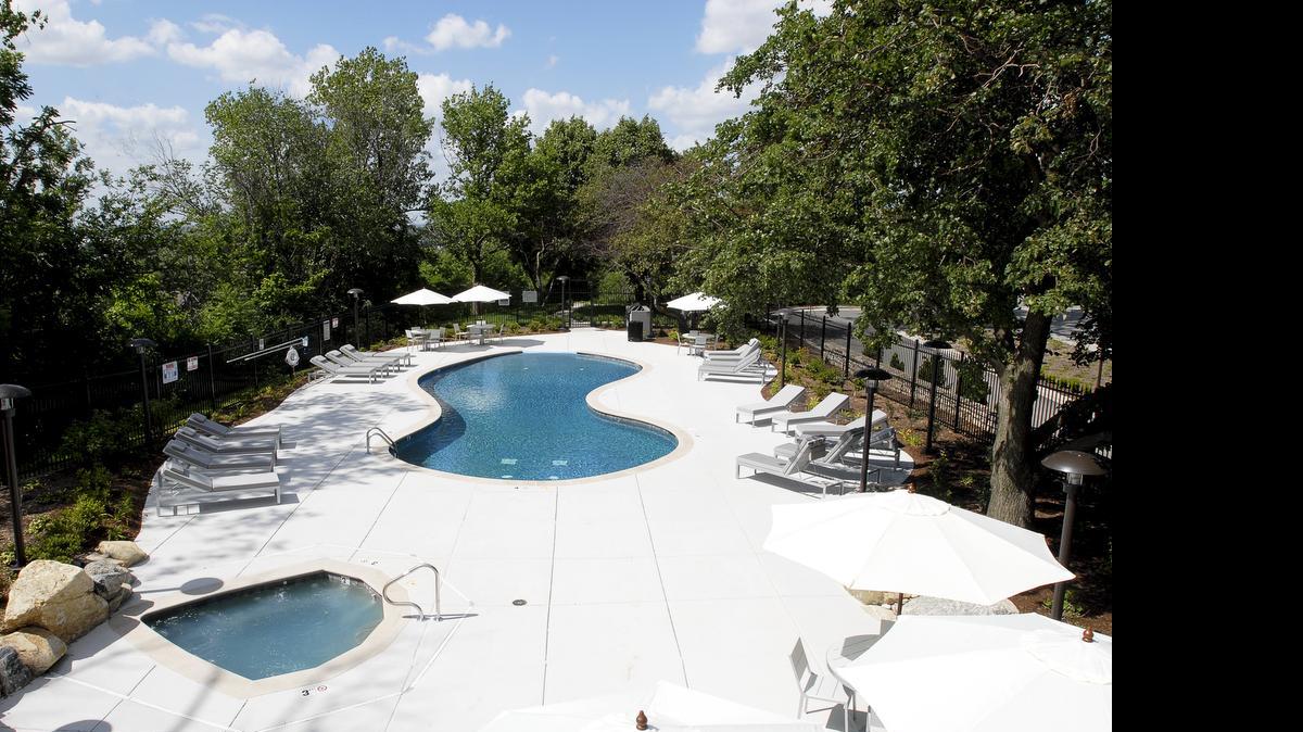 
A private, landscaped outdoor entertaining area at One Park Place features a furnished patio, swimming pool, whirlpool, barbecue area, putting green and dog run.
